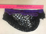 Black hay net with Purple rope + seam, laying flat on white background, with a pink ruler showing the length of approx 12 inches