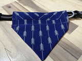 Blue over the collar dog bandana on a black collar laying flat on a wood floor