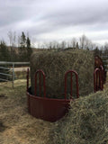 EcoNets EZ Feeder kit over a new round bale in a red metal feeder with the outside part of the bale pulled off + put to the side