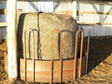 Medium round bale net in a brown feeder